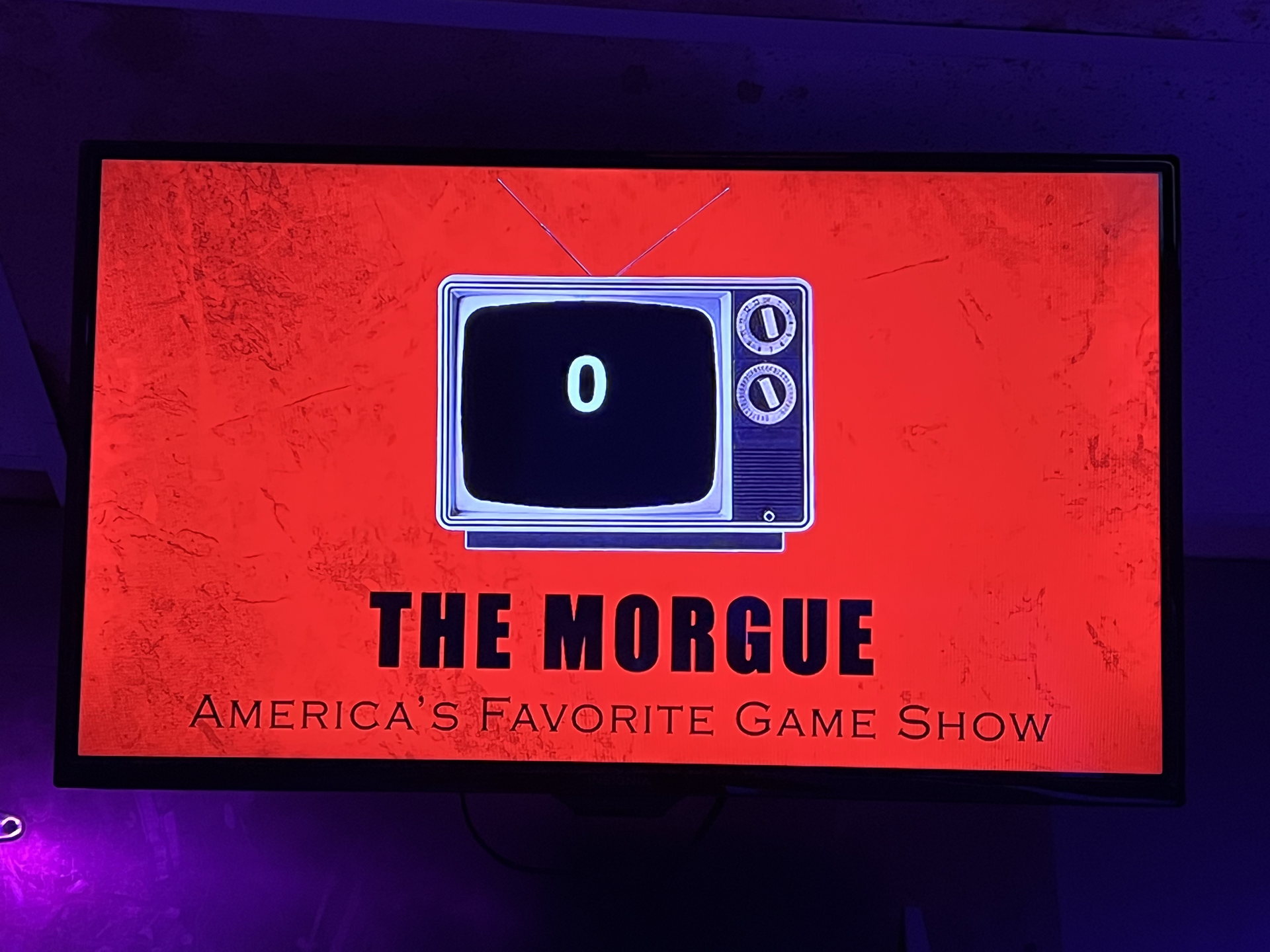 A red television title screen inside The Morgue game room